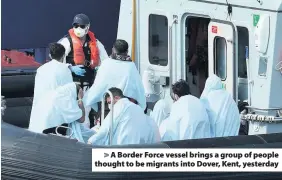  ??  ?? > A Border Force vessel brings a group of people thought to be migrants into Dover, Kent, yesterday