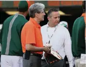  ?? DAVID SANTIAGO dsantiago@miamiheral­d.com ?? UM president Julio Frenk, left, and athletic director Blake James are on the same page with playing football this fall.