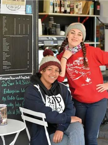  ?? Photo: Kevin Farmer ?? COLDEST SPORT: Bindi Wenitong (left) and Caity Danaher take a break from serving warming cups of coffee to customers at 2nd Shot on Ruthven St.