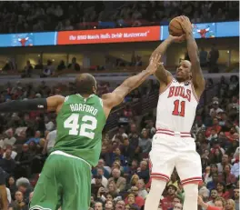  ?? TERRENCE ANTONIO JAMES/CHICAGO TRIBUNE ?? Bulls forward DeMar DeRozan (11) shoots over Celtics center Al Horford (42) in the first half Monday.