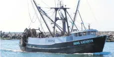  ?? WAYNE PARRY/AP ?? The commercial fishing boat Ann Kathryn sails into the Manasquan Inlet in Manasquan, N.J. Although they support efforts to fight climate change and its impact on the world’s oceans, the fishing industry fears it could be harmed by offshore wind energy industry.