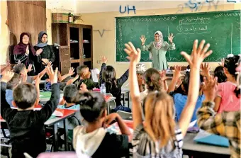  ?? ?? Displaced Palestinia­n children attend a class recently opened in a school used as a temporary shelter, in Beit Lahya. (AFP)