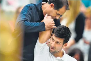  ?? AFP ?? Serbia's Novak Djokovic gets treatment for his shoulder injury during the match against Adrian Mannarino.