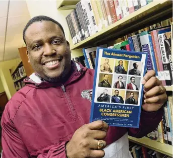  ?? Arnold Gold/Hearst Connecticu­t Media ?? Darryl Brackeen, Jr., is photograph­ed with his book, The Almost Forgotten: America's First Black American Congressme­n, at Southern Connecticu­t State University's Buley Library in New Haven on Wednesday.