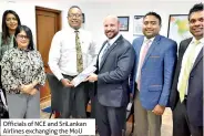  ??  ?? Officials of NCE and Srilankan Airlines exchanging the MOU