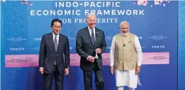  ?? — AP ?? Japanese Prime Minister Fumio Kishida (left), US President Joe Biden and Prime Minister Narendra Modi pose for photograph­s as they arrive at the Indo-Pacific Economic Framework for Prosperity launch event at the Izumi Garden Gallery in Tokyo on Monday.