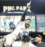  ?? Charles Leclaire ?? USA Today Josh Harrison, top, rejoices with his Pirates teammates after hitting a walk-off home run in the 10th inning of Pittsburgh’s 1-0 win over the Dodgers on Wednesday at PNC Park.