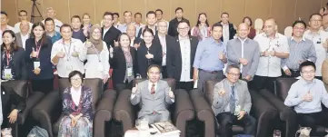  ??  ?? Liam (seated third right) with the Forest senior staff and participan­ts in a photocall at the seminar closing ceremony.