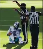  ?? BRANDON WADE – AP ?? Cowboys quarterbac­k Dak Prescott sits on the turf after injuring his right ankle.