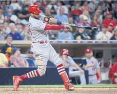  ?? AP ?? The Cardinals’ Jose Martinez swings on a home run during the seventh inning against the Padres in San Diego.