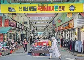  ?? Marcus Yam Los Angeles Times ?? BUSINESS has been slow at Jungang Market in Chuncheon, South Korea, during the pandemic. Stimulus checks, which must be spent locally, aim to reverse that.