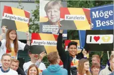  ?? — AFP ?? Supporters of German Chancellor Angela Merkel of the Christian Democratic Union party hold banners before a TV debate with her challenger Germany’s Social Democratic Party SPD candidate for chancellor Martin Schulz in Berlin.