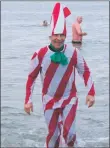  ?? KC_c02dipford­osh02 ?? Dalintober Beach Group chairman Jamie Maclean emerges from the water dressed as a candy cane.