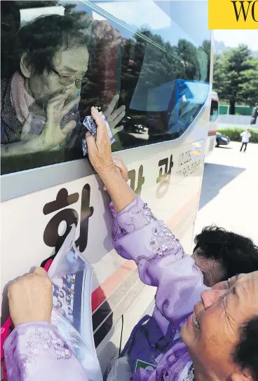  ?? LEE JI-EUN / YONHAP VIA AP ?? North Korean Kim Kyong Sil, 72, right, reaches up to touch the bus window where her South Korean mother Han Shin-ja, 99, sits, after a rare family reunion meeting at Diamond Mountain resort in North Korea Wednesday.