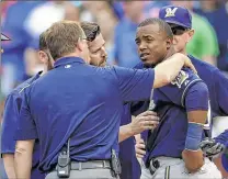  ??  ?? ASSOCIATED PRESS Brewers shortstop Jean Segura is checked out after being hit on the head in the eighth inning by Cubs pitcher Pedro Strop.