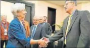  ?? AFP ?? IMF Managing Director Christine Lagarde (left) greets Pakistan finance minister Asad Umar in Bali.
