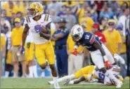  ?? MATTHEW HINTON — ASSOCIATED PRESS ?? LSU wide receiver D.J. Chark returns a punt for a touchdown as cornerback Andraez Williams blocks Auburn’s Eli Stove during the second half of Saturday’s game in Baton Rouge, La.