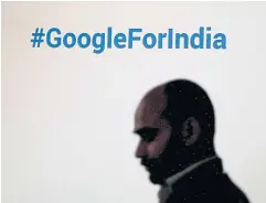  ?? ?? A man walks past a Google hashtag during an event in New Delhi, India.