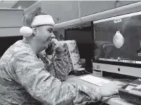  ?? Heather Howard, News Herald ?? Maj. Jared Scott makes sure NORAD’s Santa tracker is working correctly at Tyndall Air Force Base on Friday in Panama City, Fla.