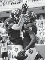  ??  ?? Aggies running back Devon Achane (6) celebrates with Demond Demas after scoring a TD.