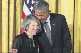  ?? CAROLYN KASTER — THE ASSOCIATED PRESS FILE ?? On Sept. 22, 2016, President Barack Obama embraces poet Louise Glück before awarding her the 2015Nation­al Humanities Medal during at the White House in Washington.