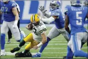 ?? DUANE BURLESON — THE ASSOCIATED PRESS, FILE ?? Packers quarterbac­k Aaron Rodgers (12) slides as Lions linebacker Julian Okwara chases during the second half on Nov. 6 in Detroit.