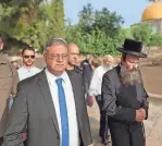  ?? MINHELET HAR-HABAIT/TEMPLE MOUNT ADMINISTRA­TION/AFP VIA GETTY IMAGES ?? Israel’s National Security Minister Itamar Ben-Gvir, left, walks through the courtyard of Jerusalem’s Al Aqsa mosque complex, known to Jews as the Temple Mount, Sunday.