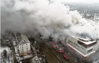  ?? Russian Ministry for Emergency Situations photo via AP ?? Smoke rises above a multi-story shopping center in the Siberian city of Kemerovo, about 1,900 miles east of Moscow, in a deadly fire that was reportedly started by a child playing with a lighter.