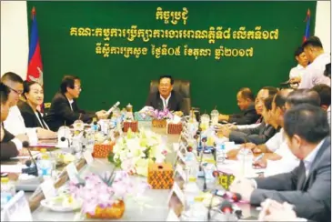  ?? PHA LINA ?? Labour Minister Ith Sam Heng (centre) chairs the Labour Advisory Committee meeting that set next year’s minimum wage for the garment and footwear sector yesterday in Phnom Penh.