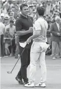  ??  ?? Brooks Koepka, left, and Rory McIlroy shake hands on the 18th green during the final round of the Tour Championsh­ip on Aug. 25.