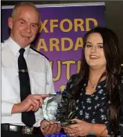  ??  ?? Eden Fitzgibbon, New Ross No Name Club, receives her award from Chief Superinten­dent John Roche.