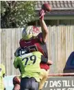  ?? Photo: Nev Madsen ?? CRUNCH: Vulture Chris Lau lays a tackle on the Raptors during their South East Queensland Gridiron match last year.
