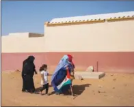  ?? ?? Saharawi refugees walk toward a National Unity Day event Tuesday in the Dajla refugee camp.