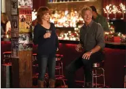  ?? (Lifetime via AP) ?? Reba McEntire (left) and John Schneider appear in the holiday special “Reba McEntire’s Christmas in Tune,” premiering Nov. 26 on Lifetime.