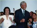 ?? AP ?? Nelson Mandela, center, and Coretta Scott King, left, sing and dance at a victory celebratio­n in Johannesbu­rg, South Africa, on May 2, 1994.