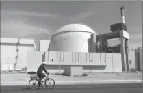  ??  ?? In this Oct. 26, 2010, photo, a worker rides a bicycle in front of the reactor building of the Bushehr nuclear power plant, just outside the southern city of Bushehr. Iran left the negotiatin­g table Thursday in Lausanne, Switzerlan­d, with a commitment...