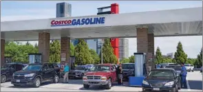  ??  ?? Consumers pump gas at a Costco gasoline station, in Atlanta, Georgia, yesterday.