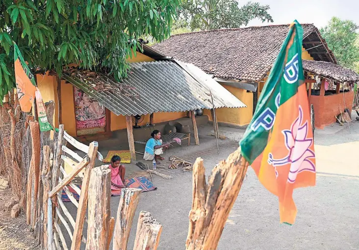  ?? AFP ?? BJP flags put up at the entrance of a residentia­l colony in Sukma district of Chhattisga­rh, where more than 85% of the population belongs to the Scheduled Tribes and 65% of the area is covered with forests.