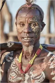  ??  ?? A Karo tribesman with an AK-47 in the village of Dus. One tour guide noted, “The AK-47 has replaced the spear.” The weapon costs “five cows,” a man said.