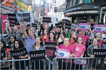  ?? FRANK FRANKLIN II/THE ASSOCIATED PRESS ?? Protestors gather Wednesday in Times Square in New York. President Donald Trump declared a ban on transgende­r troops serving anywhere in the U.S. military, catching the Pentagon flat-footed and unable to explain what it called Trump’s ‘guidance.’ His...