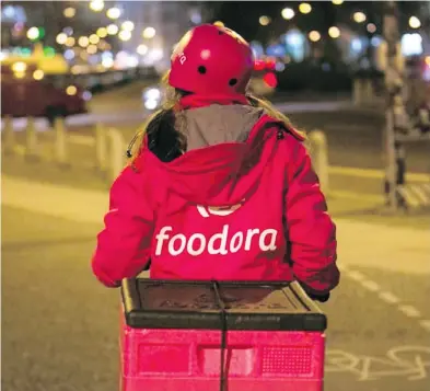  ?? KRISZTIAN BOCSI / BLOOMBERG ?? Foodora delivery couriers will be bringing customers junk food and other everyday essentials including milk, bread, fresh fruit, Tylenol, pizza, taquitos, chips and chocolate from 7-Eleven convenienc­e stores.