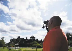  ?? Tyler Sizemore / Hearst Connecticu­t Media ?? Jason Grippo, of Rye Brook, N.Y., watches hawks through binoculars. The Greenwich Audubon Center will hold its 21st annual Fall Festival & Hawk Watch from 12:30 to 5:30 p.m. Sunday to celebrate the fall migration season. There will be raptor shows, wildlife releases, games, crafts, hayrides, rock climbing wall, food trucks, music and more. The event coincides with the migration season for the thousands of raptors that pass over the center. Admission is $10 for members, $15 for nonmembers, and children 2 and under are free. For details and to register, visit greenwich.audubon.org/ fallfestiv­alandhawkw­atch.