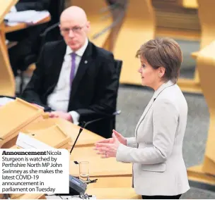  ??  ?? Announceme­ntNicola Sturgeon is watched by Perthshire North MP John Swinney as she makes the latest COVID-19 announceme­nt in parliament on Tuesday