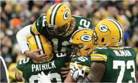  ?? Photograph: Morry Gash/AP ?? Green Bay’s Aaron Rodgers is congratula­ted after throwing his 443rd career touchdown pass during the first half of Saturday’s game against the Cleveland Browns.