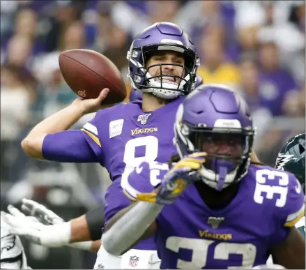  ?? BRUCE KLUCKHOHN - THE ASSOCIATED PRESS ?? Minnesota Vikings quarterbac­k Kirk Cousins, center, throws a pass during the first half of an NFL football game against the Philadelph­ia Eagles, Sunday, Oct. 13, 2019, in Minneapoli­s.