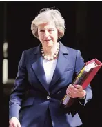  ?? PHOTOS: REUTERS ?? UK Prime Minister Theresa May