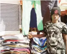  ??  ?? Abdullahi Aliyu sells hoodies and sweatshirt­s during the harmattan while he sells skirts when the weather is warm.