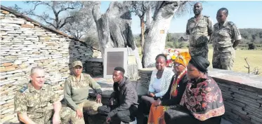  ?? ?? The head ranger, Cathy Dreyer, unveiled and read the plaque of a late field ranger and dog handler, Shando Mathebula. With her is Shando Mathebula’s family, the managing executive, Gareth Coleman, regional ranger Tinyiko Golele and section ranger Ndwakhulu Mutobvu.