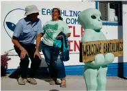  ?? AP PHOTO BY JOHN LOCHER ?? Little A’le’inn owner Connie West, right, laughs with Kirk Schultz outside of the bar and restaurant, Wednesday, Sept. 18, in Rachel, Nev. The two were helping to prepare for upcoming events spawned from the “Storm Area 51” internet hoax.