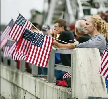  ?? SHOLTEN SINGER — THE HERALD-DISPATCH VIA AP ?? Area residents arrive to show their respect before the funeral procession for Medal of Honor recipient Hershel “Woody” Williams passes by on July 2in Teays Valley, W.Va.